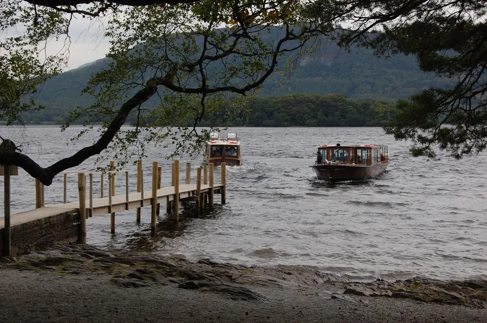 The wooden jetty at Hawes End with two launches on Derwentwater