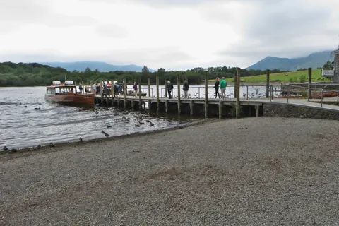 Passengers on the wooden landing stages at Keswick beside a launch