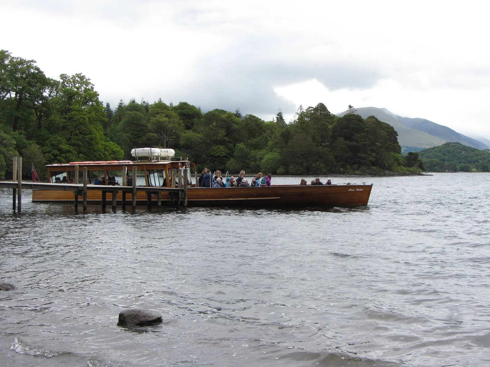 A wooden Keswick Launch boat at the Hawes End jetty on Derwentwater